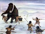 A painting of a woolly mammoth getting hunted by humans with spears